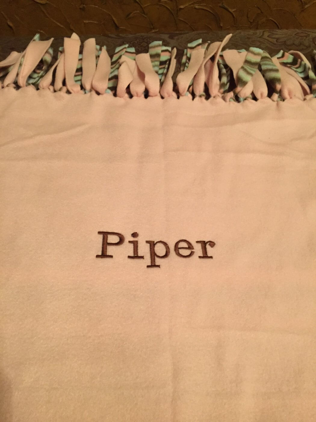 Tied embroidered fleece blanket