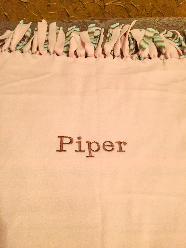 Tied embroidered fleece blanket